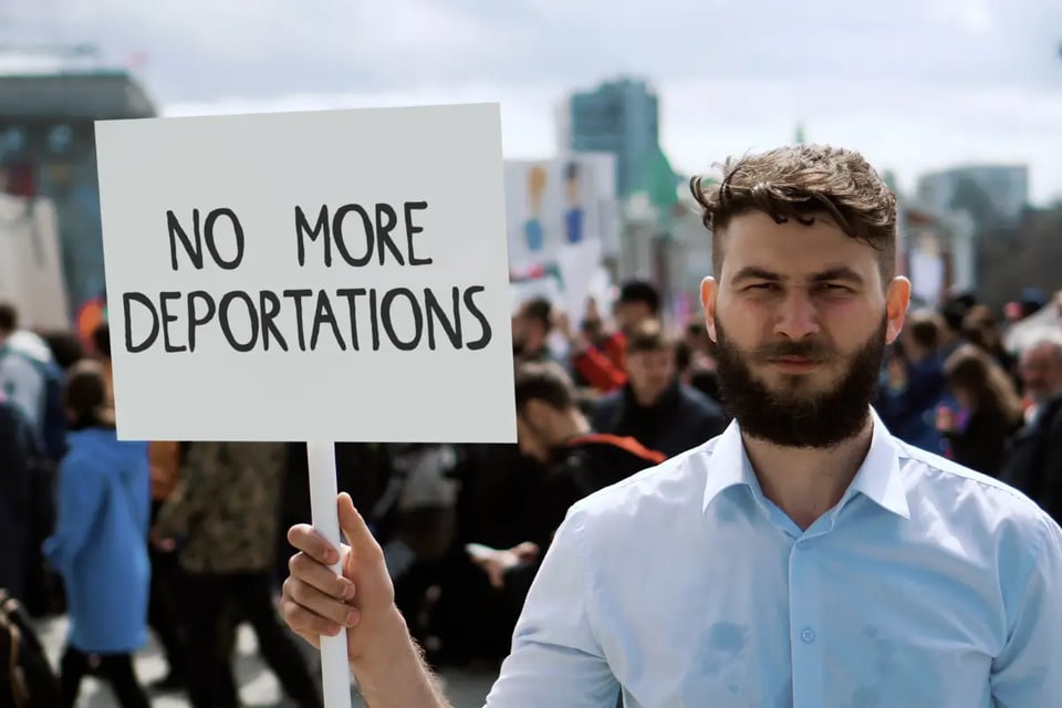 hombre protesta con cartel, fin del parole humanitario