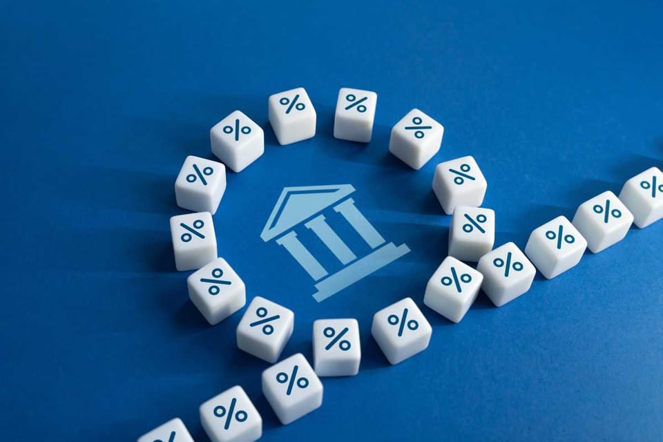 simbolos de porcentaje sobre una mesa azul, tasas de interés FED