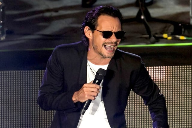 Did he come out of the closet? Marc Anthony kisses a male friend at a concert