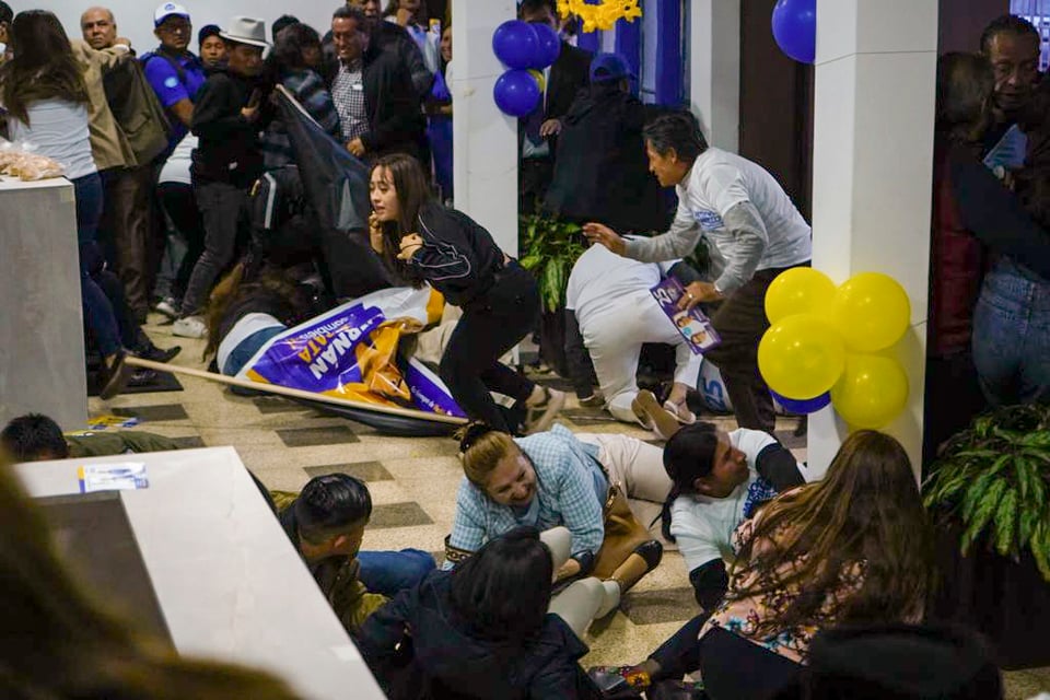 Simpatizantes del candidato presidencial Fernando Villavicencio se ponen a cubierto tras el ataque a tiros.