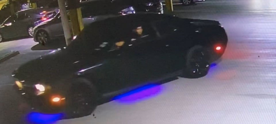black car, suspect car, crime in parking lot