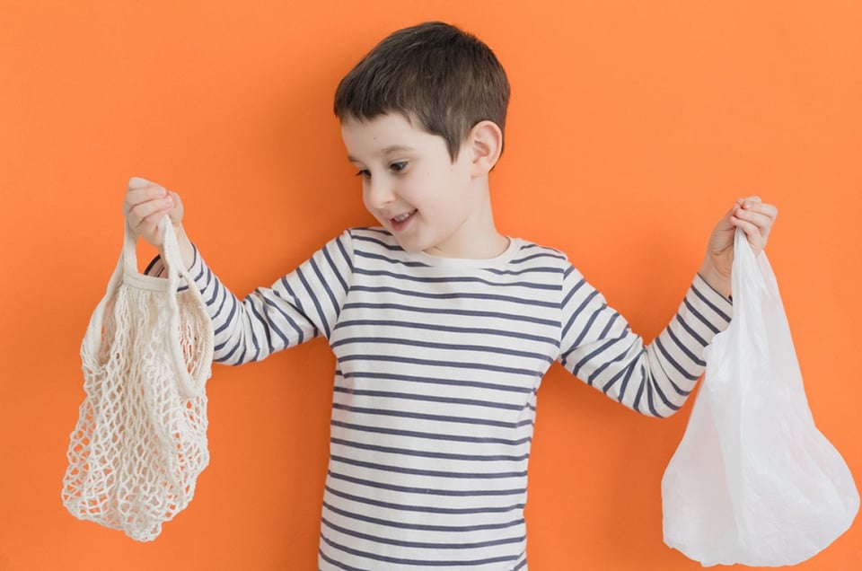 Child with cloth and plastic bag,