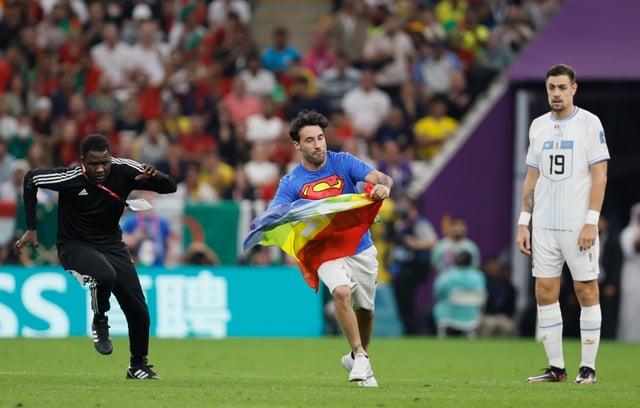 Activist runs onto the field with a rainbow flag in the middle of the Uruguay-Portugal match