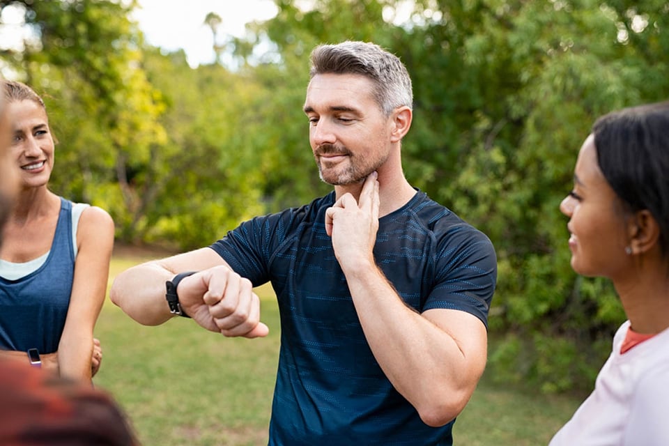 Mature tired man checking pulse, How to get fit after 40