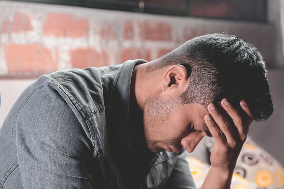 A young Latino man who is depressed