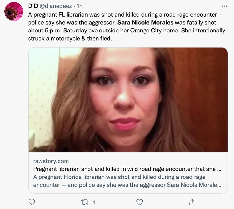 Sara Nicole Morales points her gun at the motorcyclist