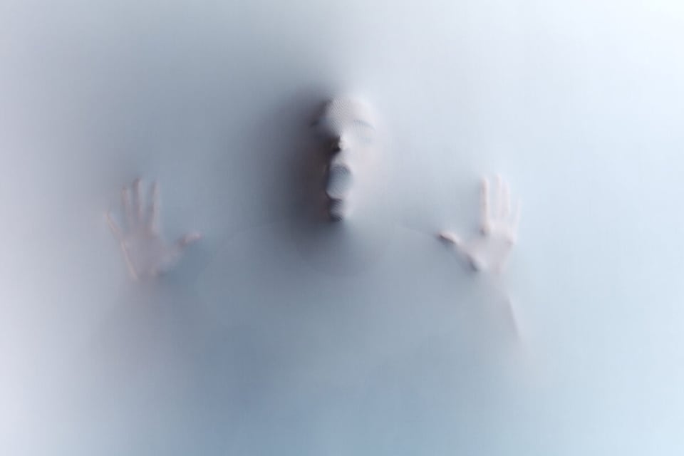 A man trapped in a white wall representing the Denver killer madness