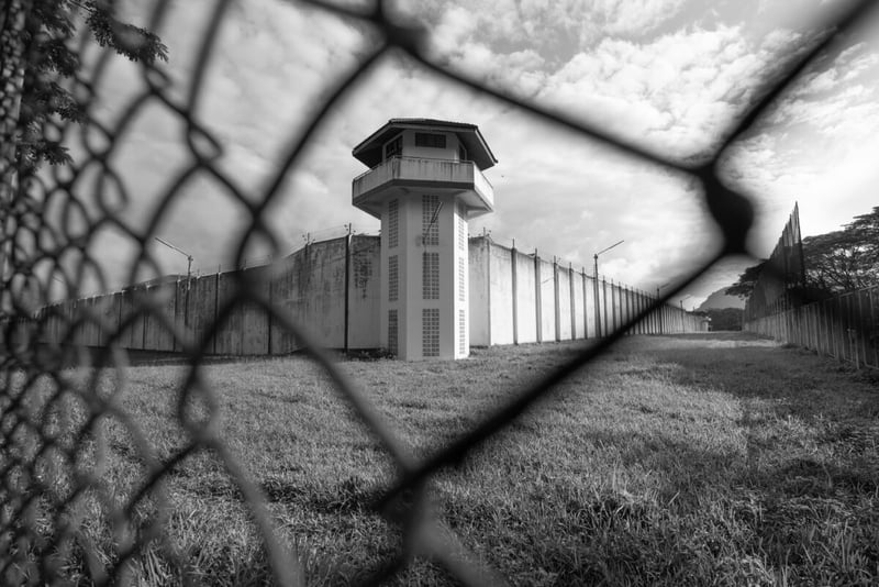 A prison seeing through a gate in black and white
