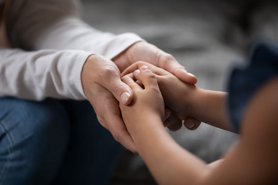 Kid and adult hands together