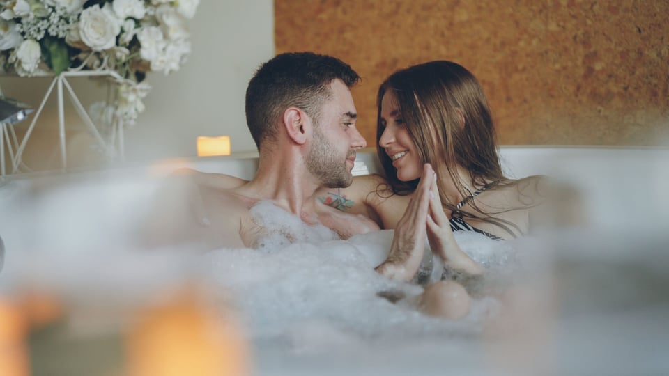 Man and woman taking a bath in tub