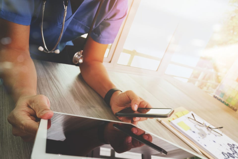 Doctor looking at phone
