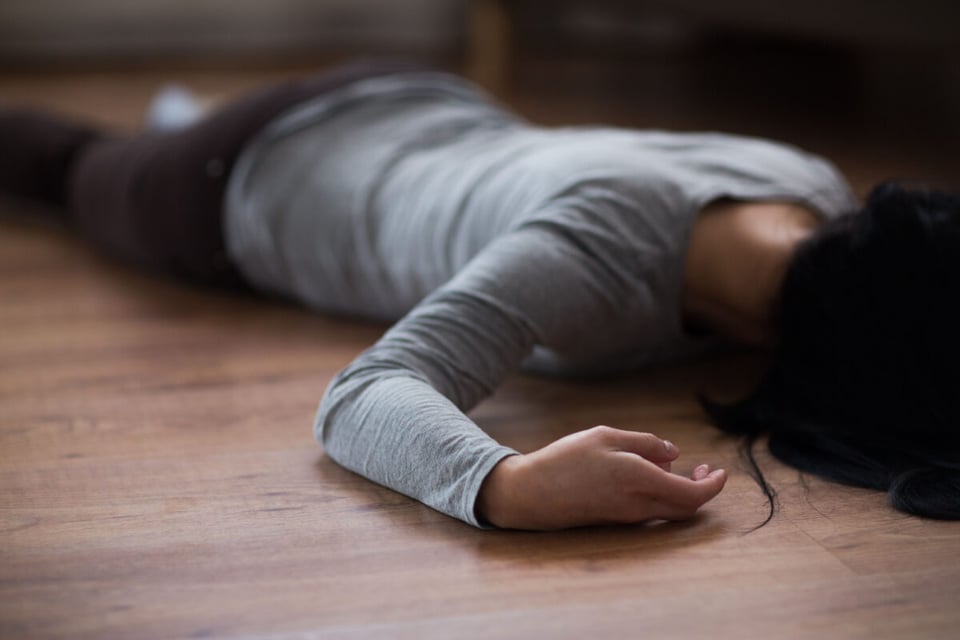 A woman on the ground after being murder