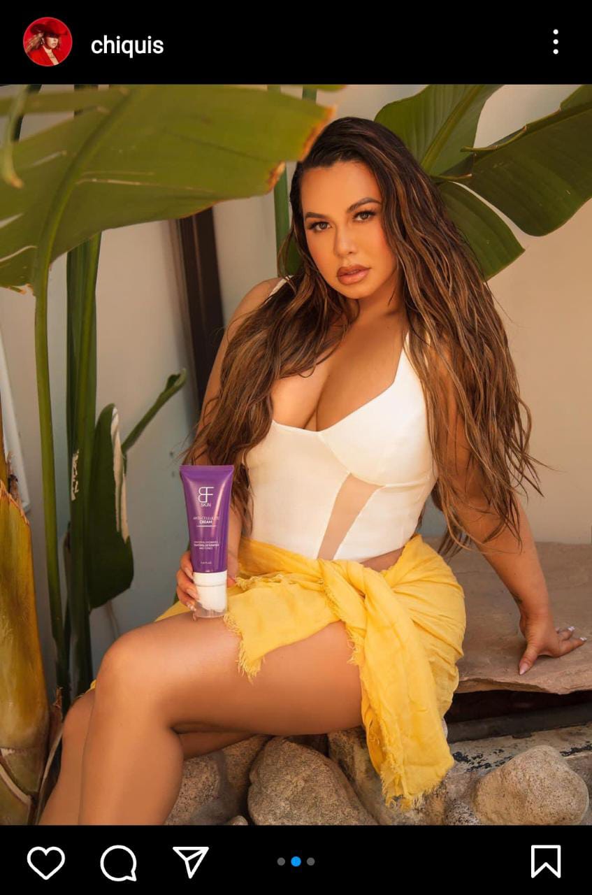 With a pronounced neckline, Chiquis poses seductively