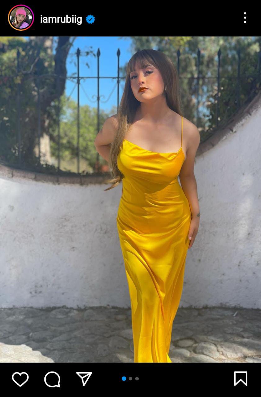 She shows off in a bright yellow skintight dress