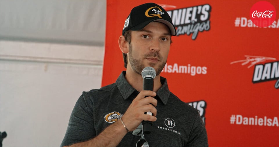 Daniel Suárez holding a microphone
