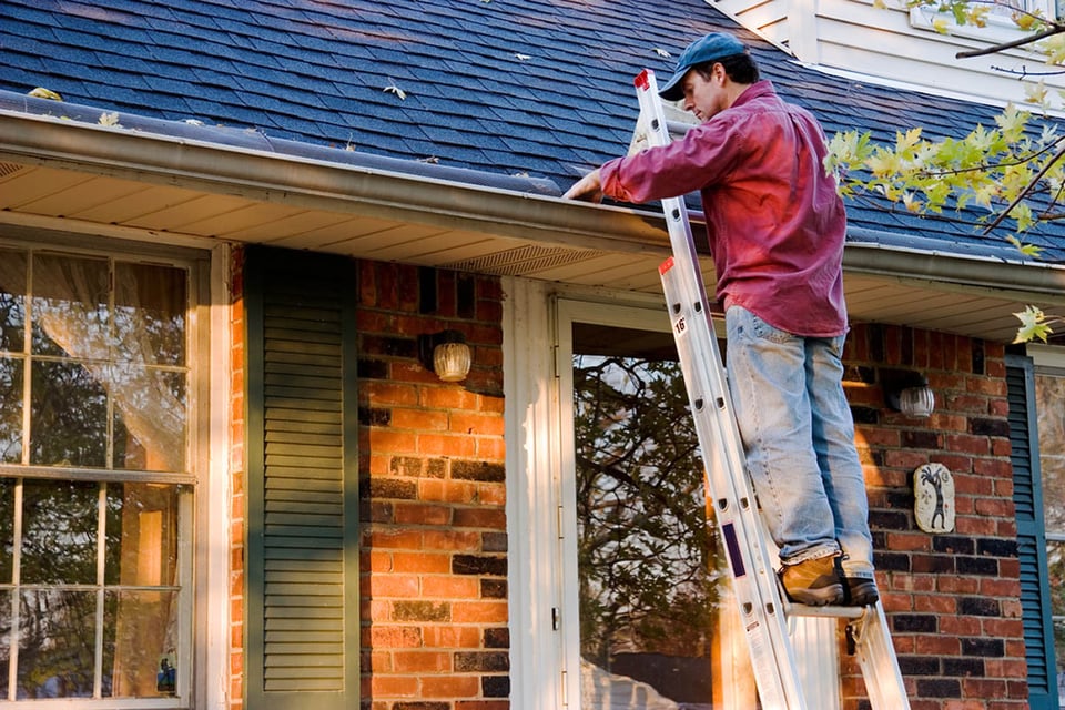 home maintenance tips, fall, repairs, home repairs, man cleaning gutters