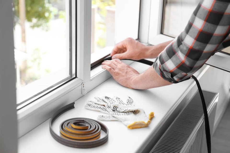 man, sealing windows, foam seal