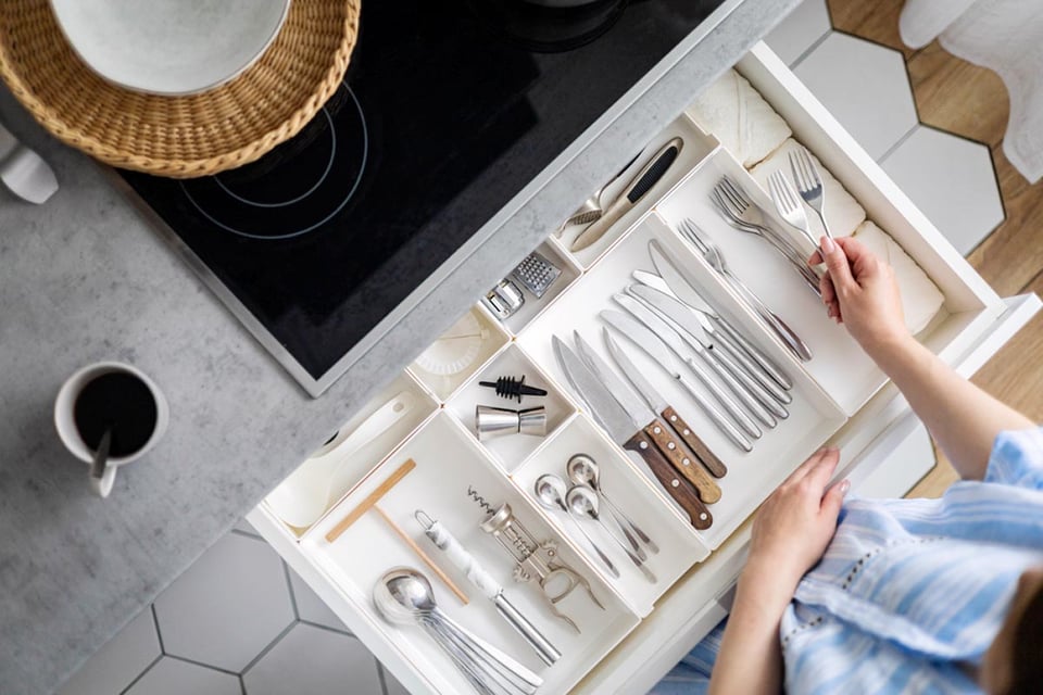 hands tidying up, cutlery in drawer, general cleaning, organize your kitchen