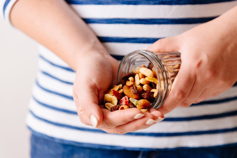 woman, nuts in a jar