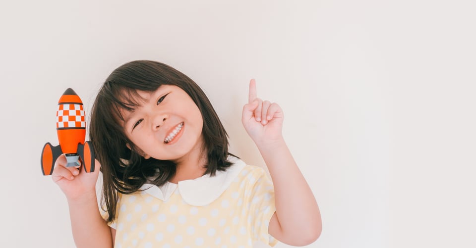 Niña con un cohete en la mano