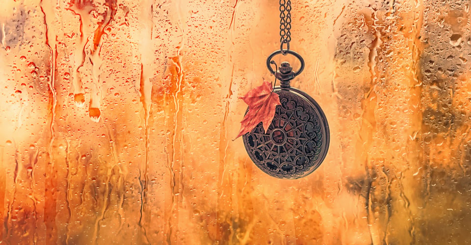 Clock with autumn leaf as equinox idea