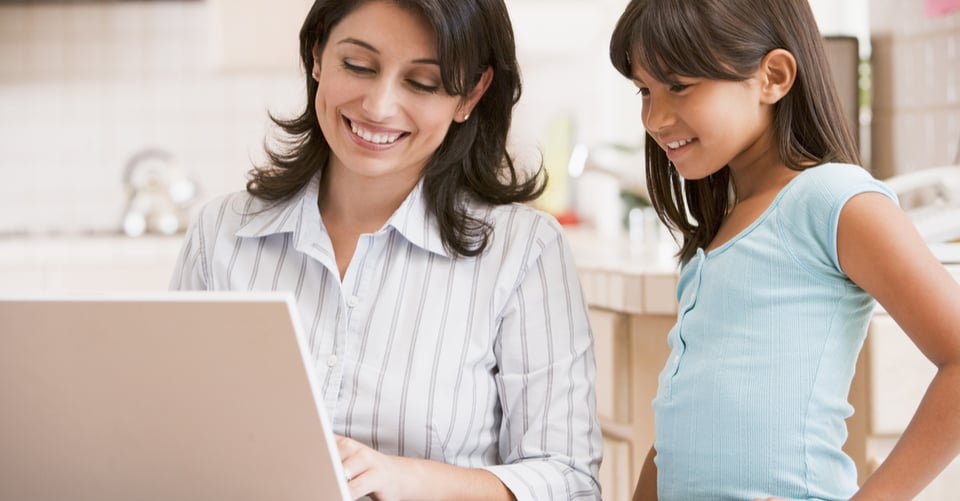 A mother with her daughter looking for dental health information