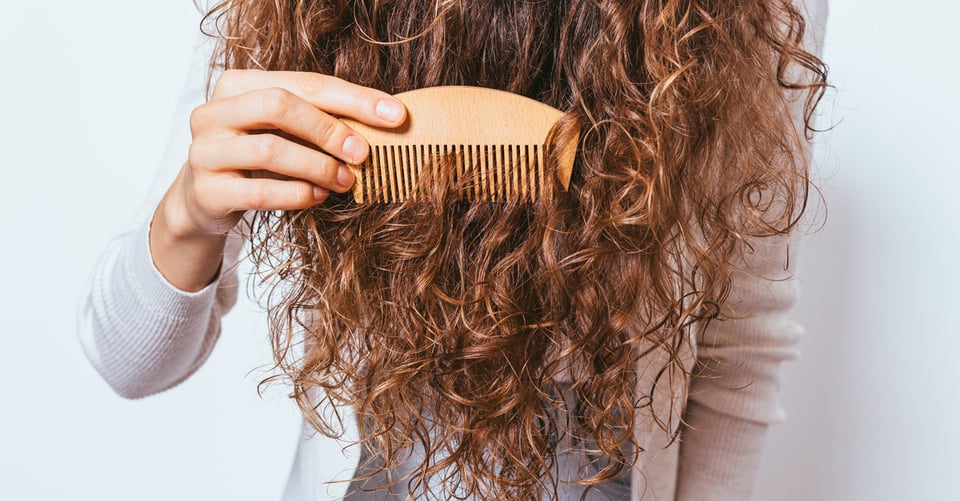 Mujer cepillando cabello con un peine