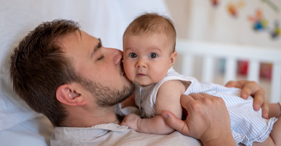 Dad with baby in bed