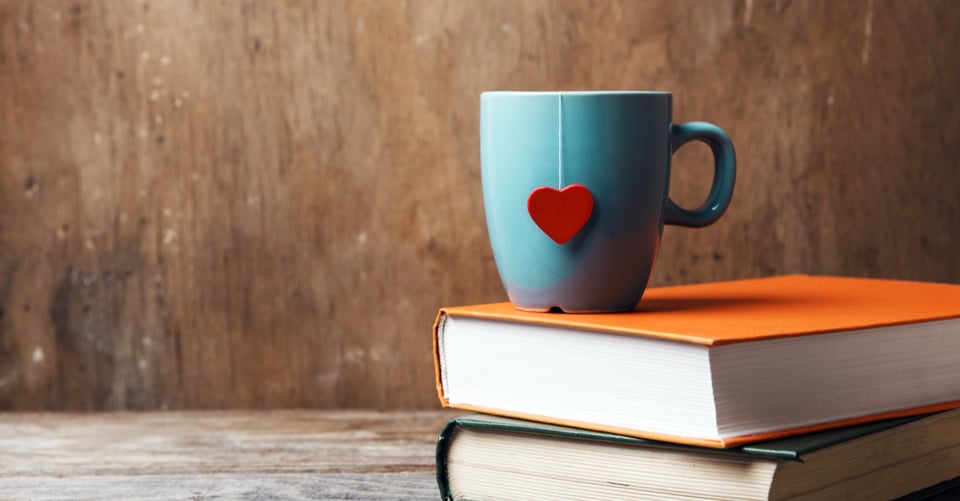 A cup on top of some novels
