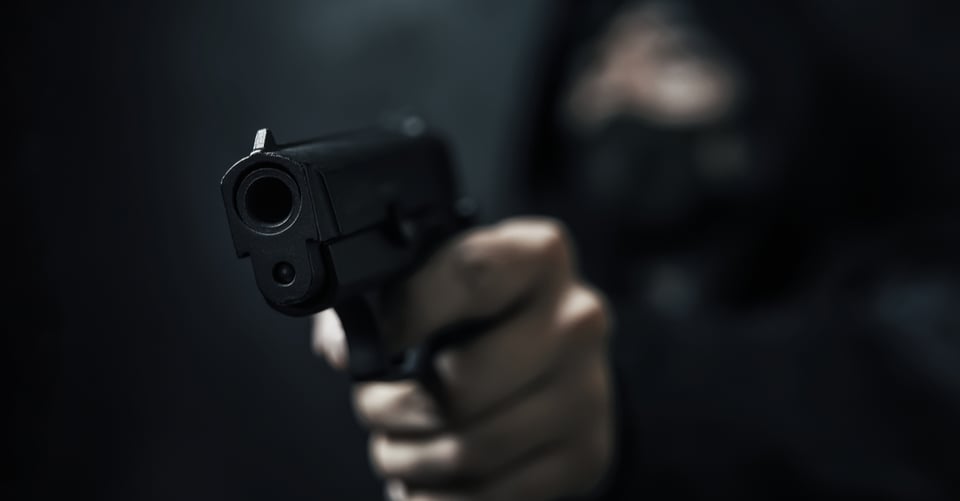 A criminal with a gun in his hand