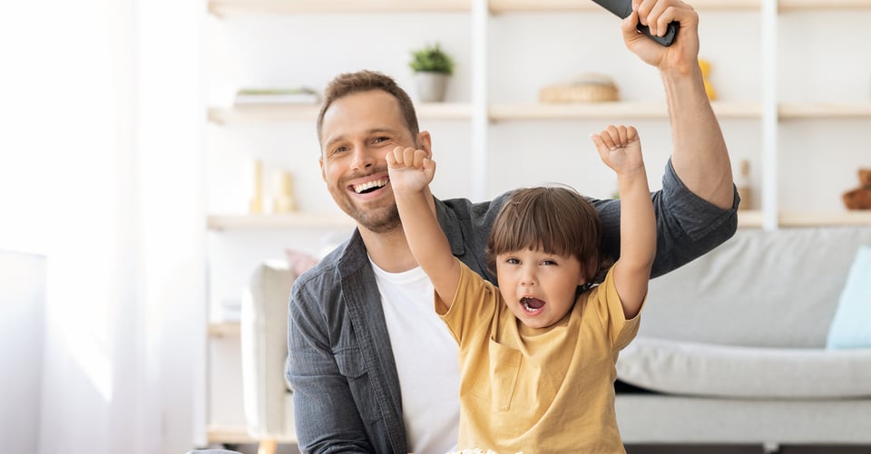 Un papá con su hijo viendo estrenos