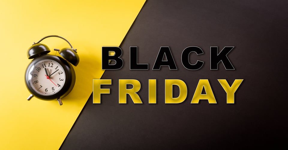 A clock with phrase black friday on yellow black background