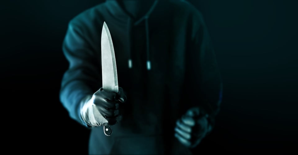 Criminal with knife in one hand
