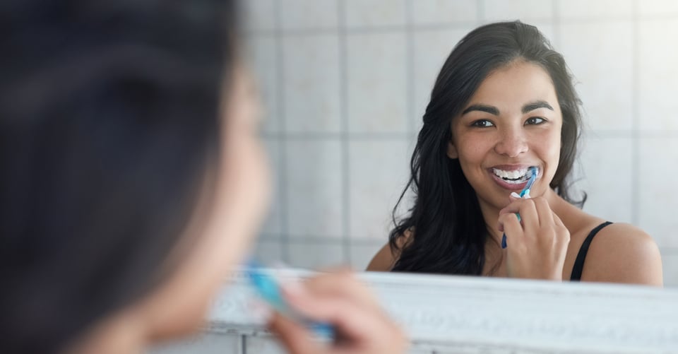 Woman in bathroom at teeth care session