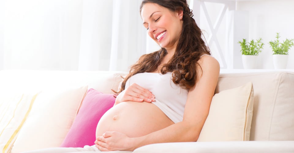 A pregnant woman smiling