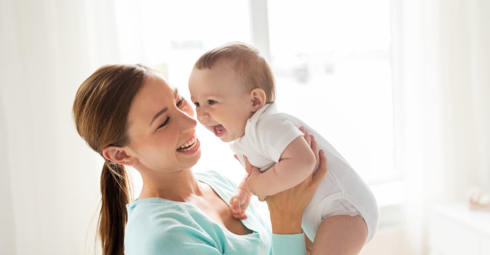 A baby with his mom happy together