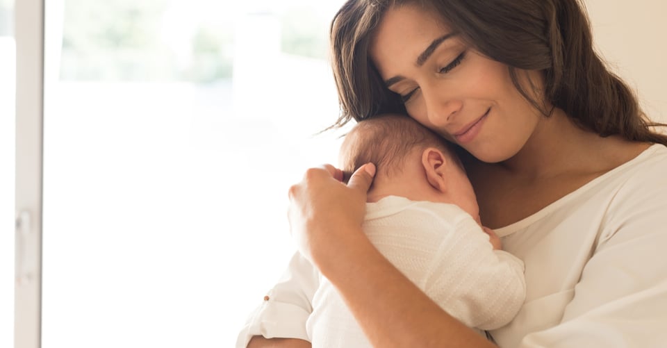 A woman with her child in her arms