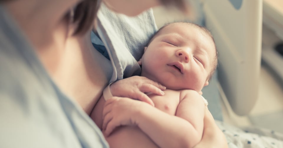 Woman with baby as motherhood concept