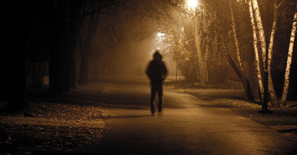 Murderer walking in a park at night