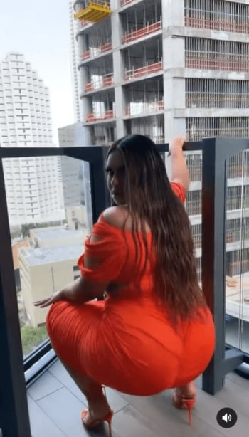 "A Christian woman should not do that."; appears twerking in an orange dress and is attacked