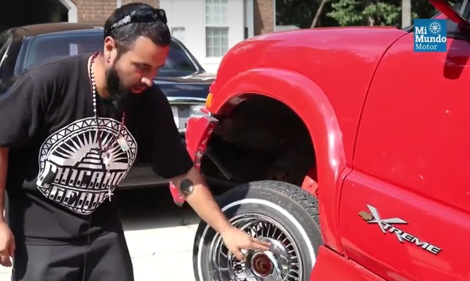 maintenance of a lowrider, chicano man, red truck, red car, MundoNOW