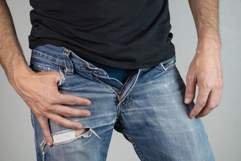 Tightening the slider and sewing, man, blue jeans