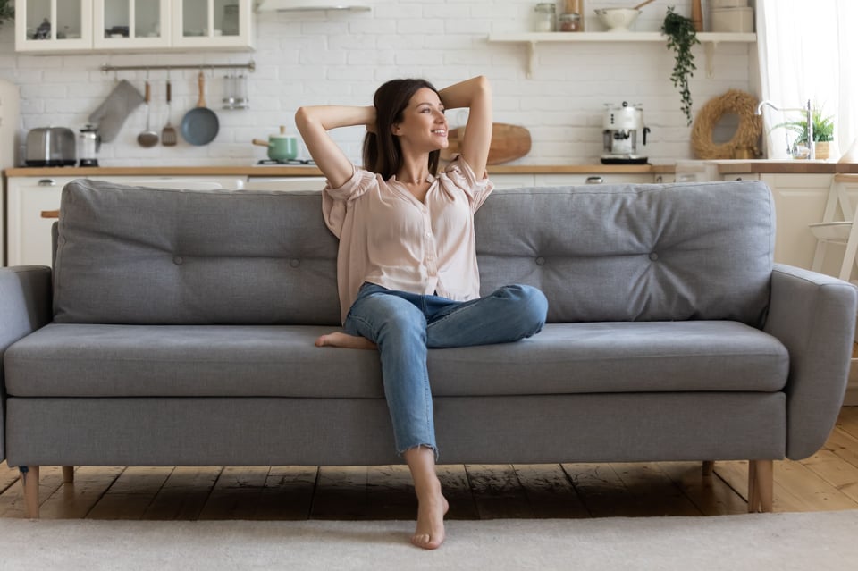 A mom taking a break on a sofa