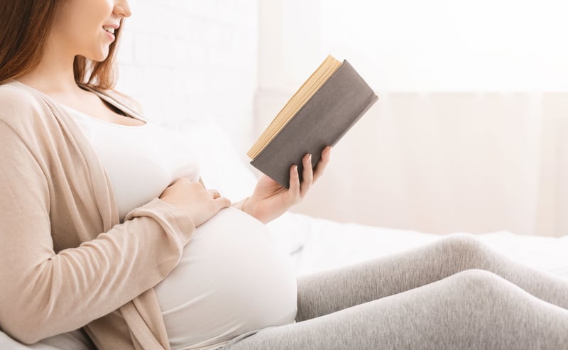 Woman reading a book during pregnancy