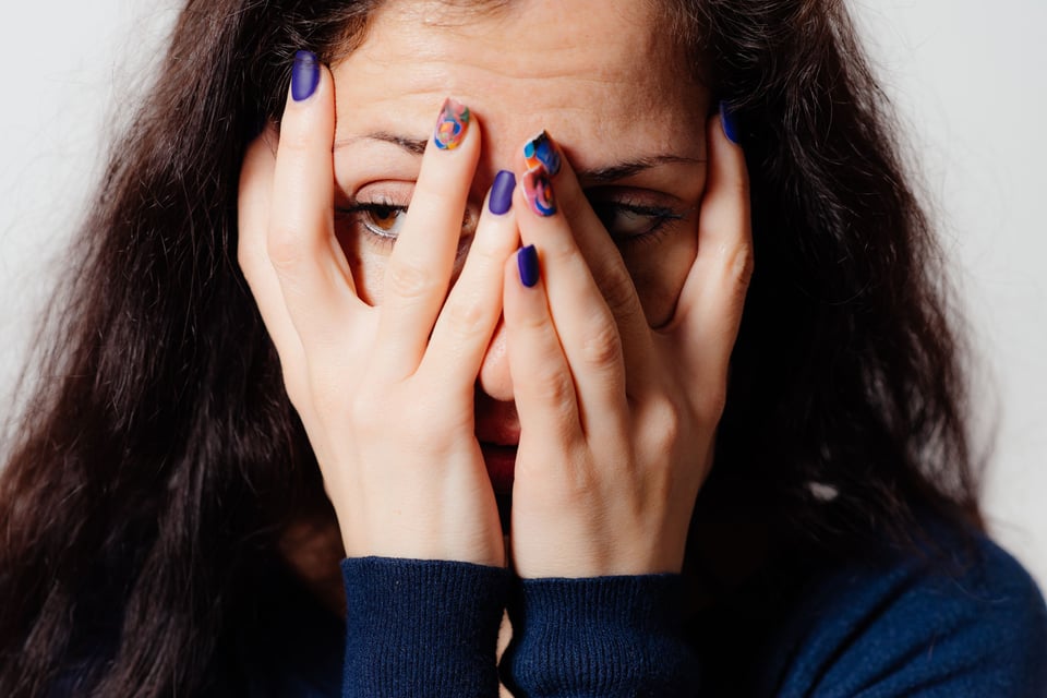 Woman covering her face with hands