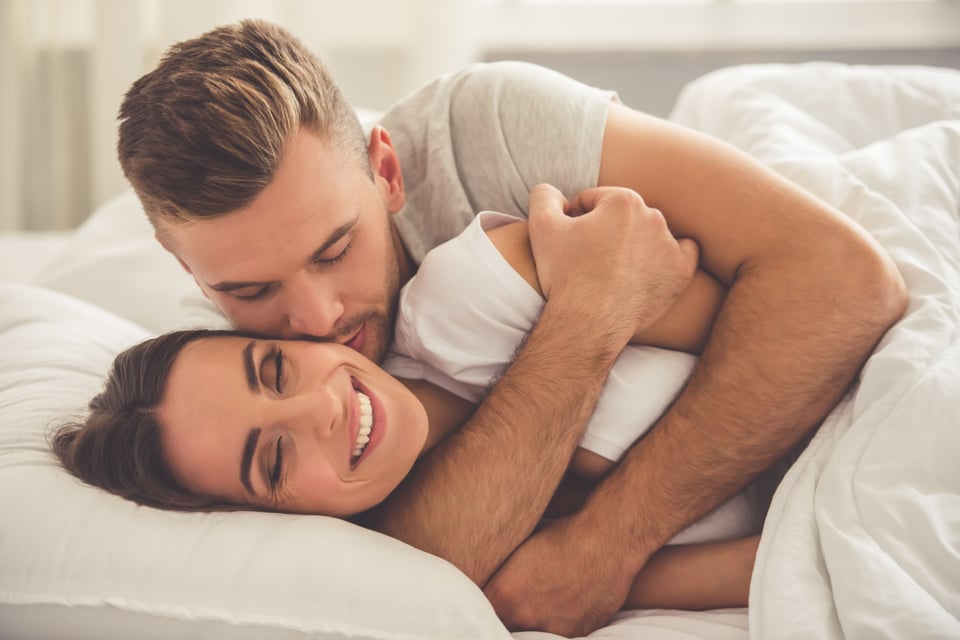 Couple in bed hugging