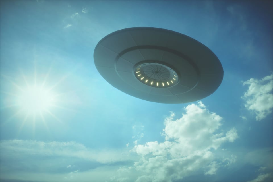 A round UFO in the near the sun