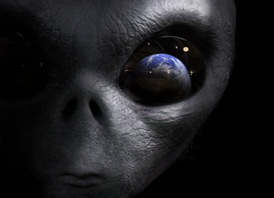 Alien face with planet Earth on his eye