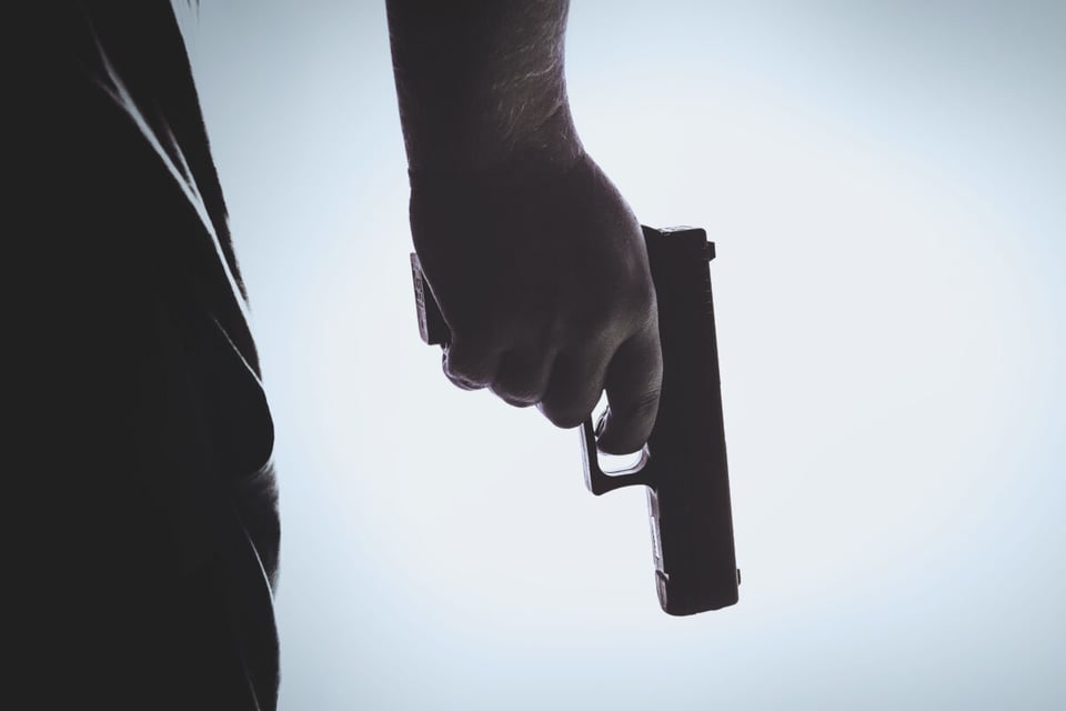 A the hand of a killer with a gun