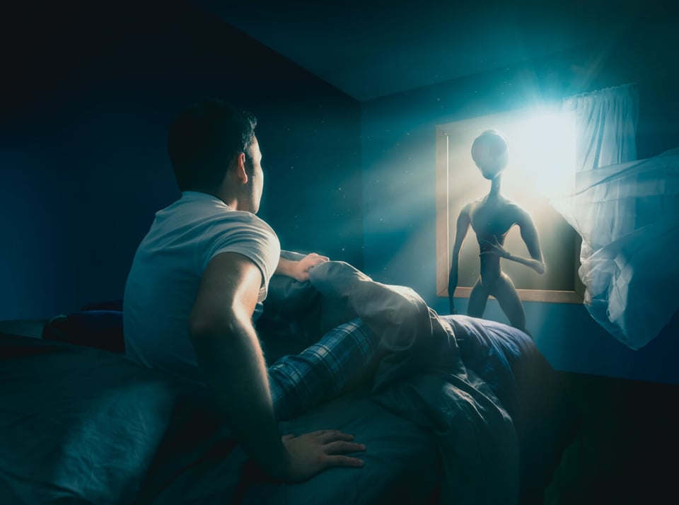 An alien entering a room through window shocking a human